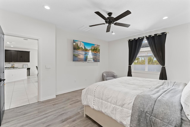 bedroom featuring ceiling fan and light hardwood / wood-style floors