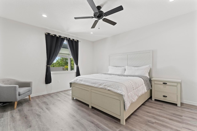 bedroom with ceiling fan and light wood-type flooring