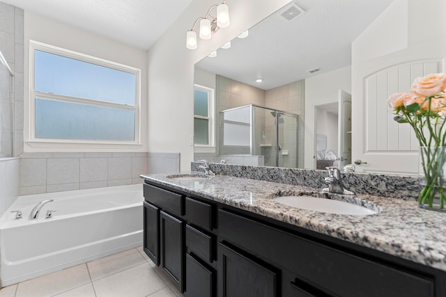 bathroom featuring vanity, tile patterned floors, shower with separate bathtub, and a textured ceiling