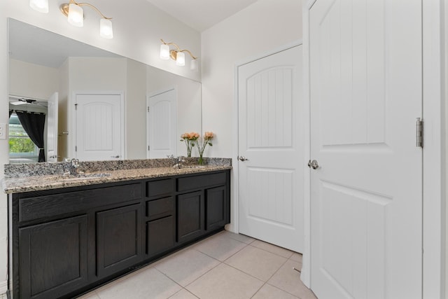 bathroom with tile patterned flooring and vanity