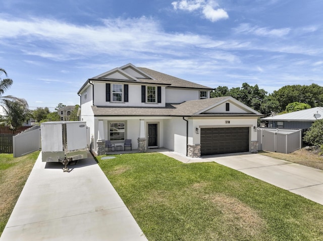 view of front of house featuring a garage and a front lawn