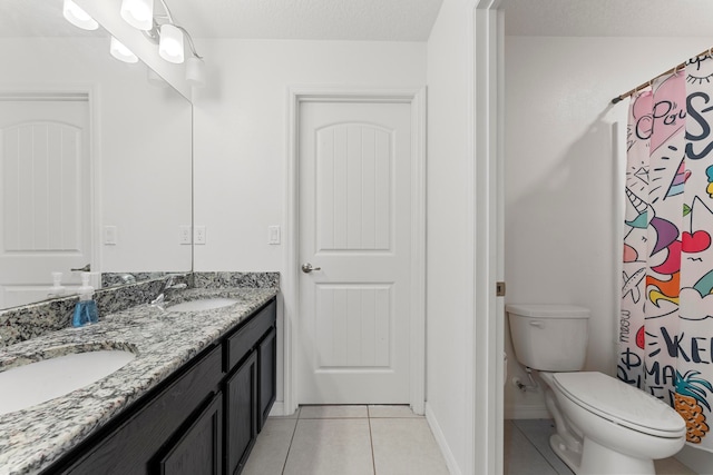 bathroom with vanity, toilet, tile patterned flooring, and a textured ceiling