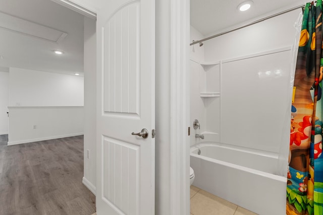 bathroom featuring shower / bath combination with curtain and toilet