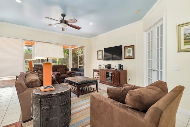 tiled living room with french doors, ornamental molding, and ceiling fan