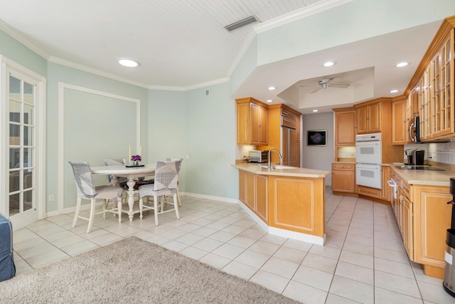 tiled living room featuring crown molding, built in shelves, and ceiling fan