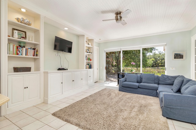 tiled living room with ceiling fan, built in shelves, and crown molding