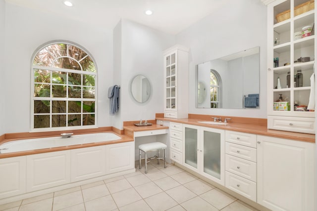 bathroom featuring shower with separate bathtub, tile flooring, and vanity