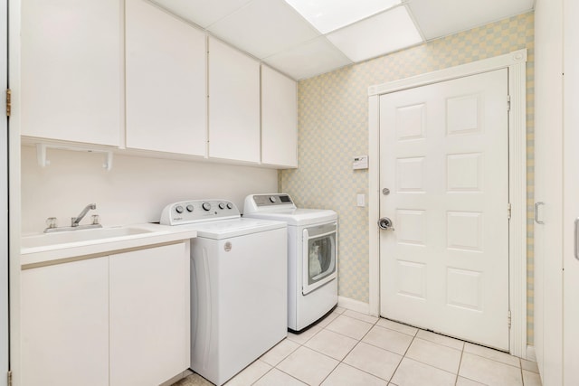 laundry area featuring cabinets, sink, independent washer and dryer, and light tile floors