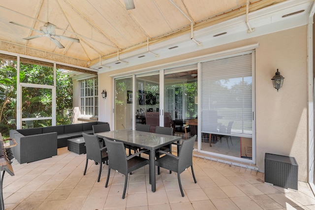 sunroom with ceiling fan and vaulted ceiling