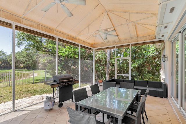 sunroom / solarium featuring lofted ceiling and ceiling fan