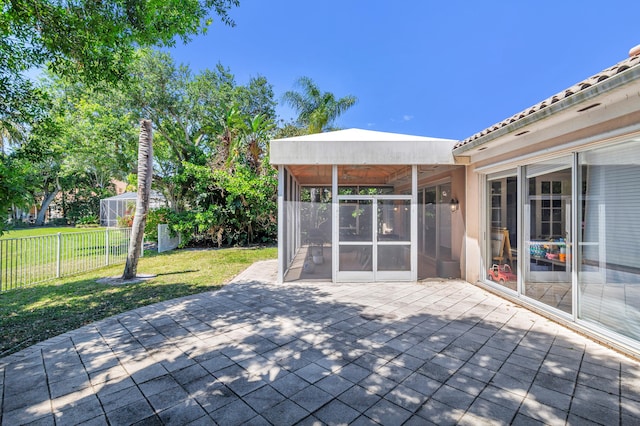 view of patio / terrace featuring a sunroom