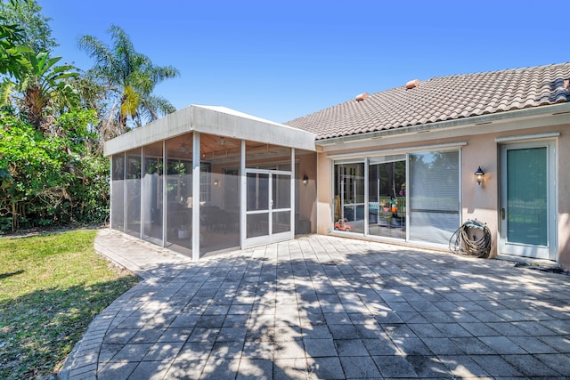 view of patio featuring a sunroom