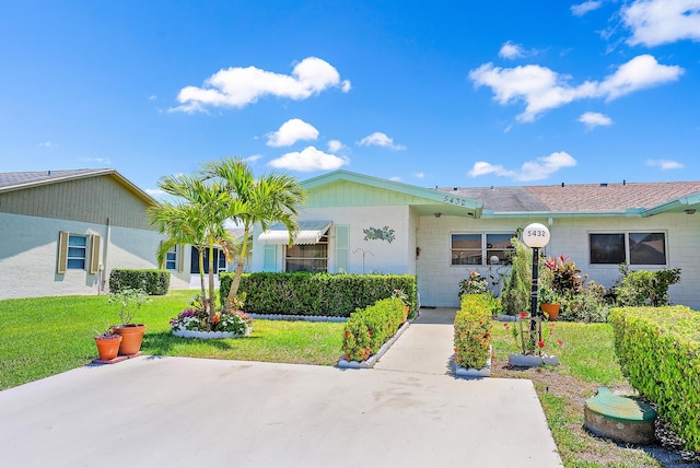 ranch-style home with a front lawn