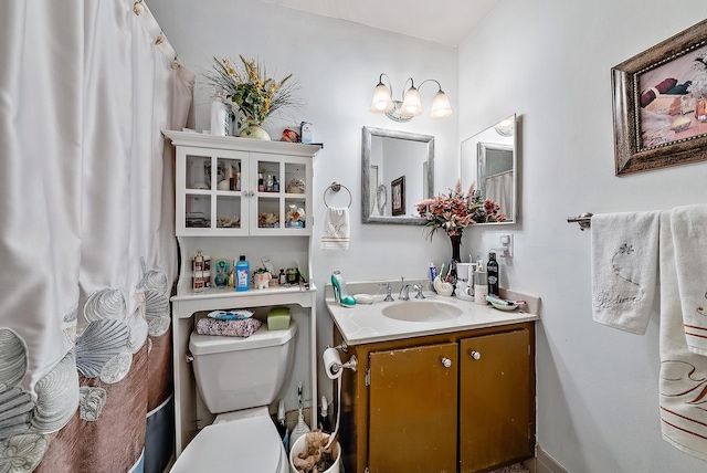 bathroom with vanity with extensive cabinet space and toilet