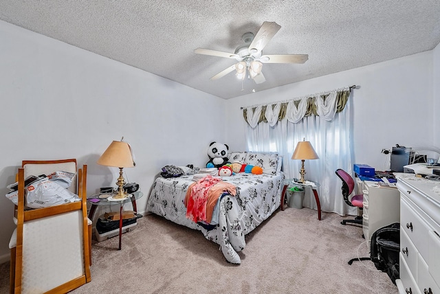 carpeted bedroom featuring ceiling fan and a textured ceiling