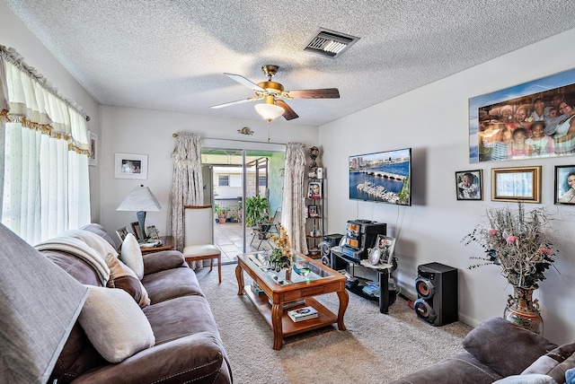 tiled living room with a textured ceiling and ceiling fan