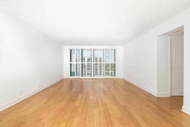 unfurnished room featuring light hardwood / wood-style floors