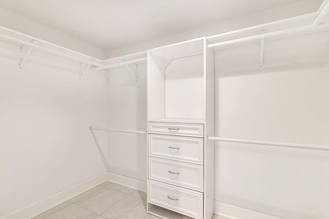 walk in closet featuring light tile patterned floors