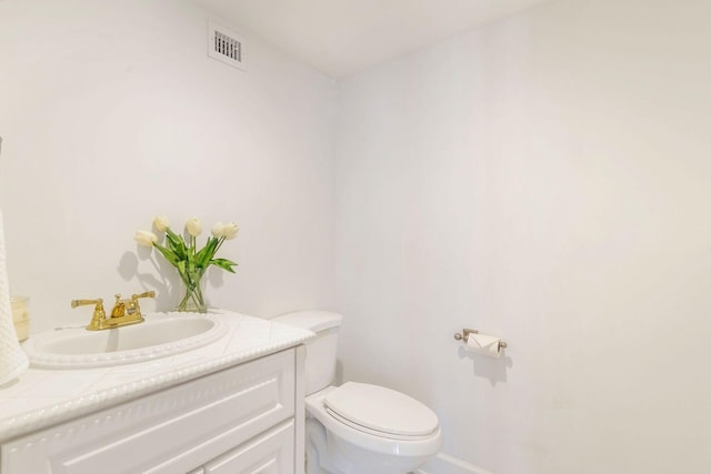 bathroom featuring toilet and vanity