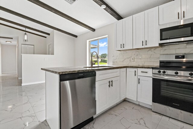 kitchen featuring lofted ceiling with beams, light tile flooring, white cabinetry, stainless steel appliances, and sink