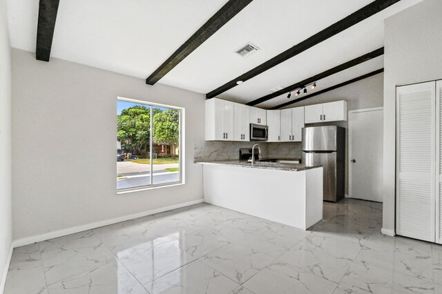 kitchen featuring appliances with stainless steel finishes, light tile floors, kitchen peninsula, and white cabinets