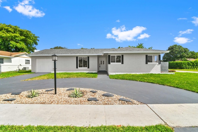 single story home with a garage and a front yard