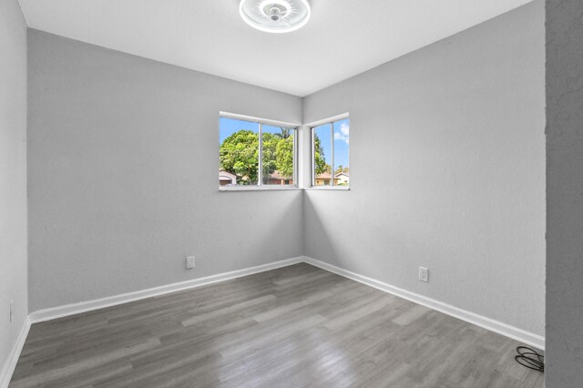 spare room with hardwood / wood-style flooring