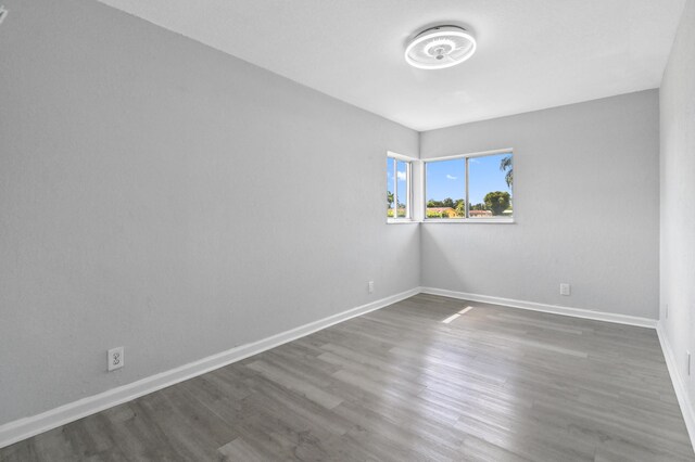 unfurnished room featuring dark wood-type flooring