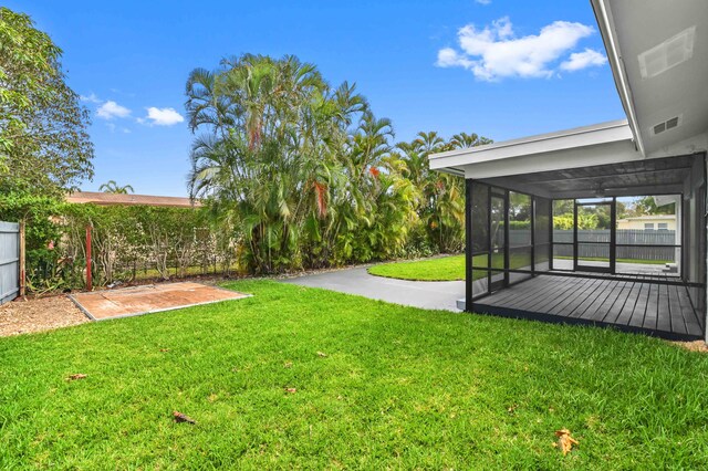 view of yard with a sunroom