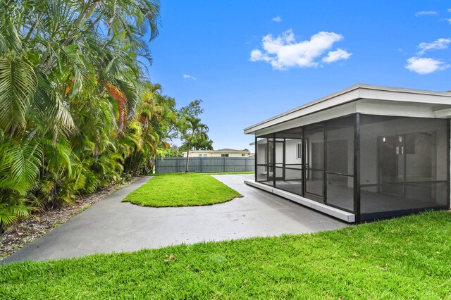 view of yard with a patio and a sunroom