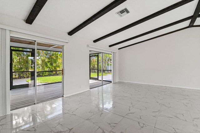 tiled spare room featuring lofted ceiling with beams