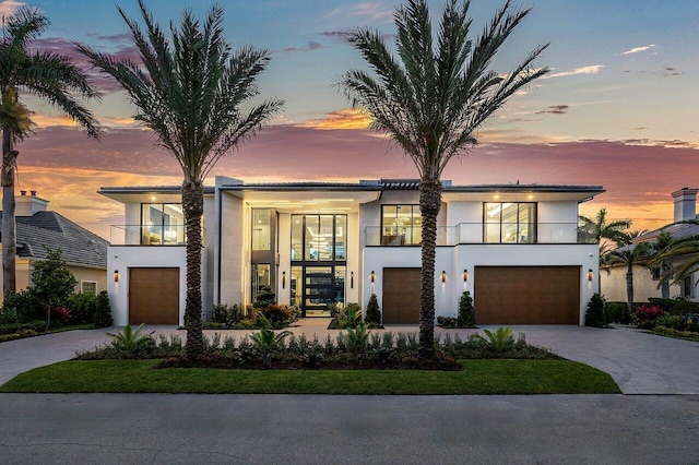 contemporary house featuring a balcony and a garage