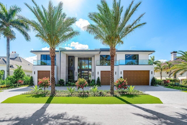 modern home featuring a balcony and a garage