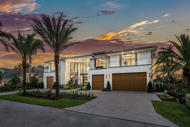 modern home featuring a garage and a balcony