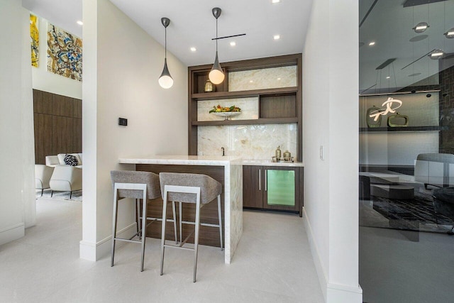 bar with decorative backsplash and pendant lighting