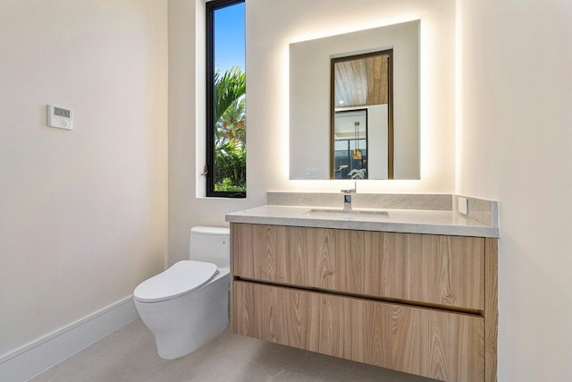 bathroom featuring vanity and toilet