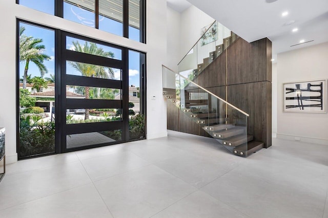 entryway with a towering ceiling