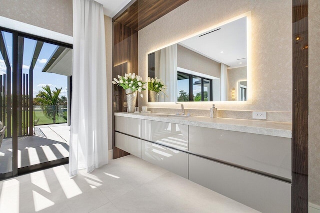 bathroom with plenty of natural light and vanity