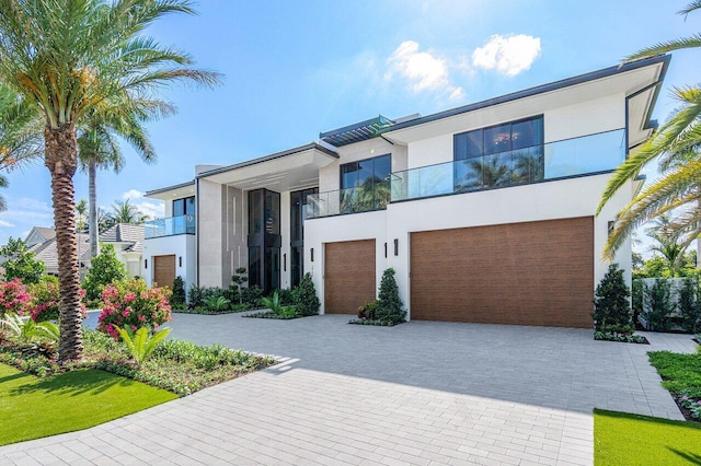 contemporary home featuring a garage and a balcony