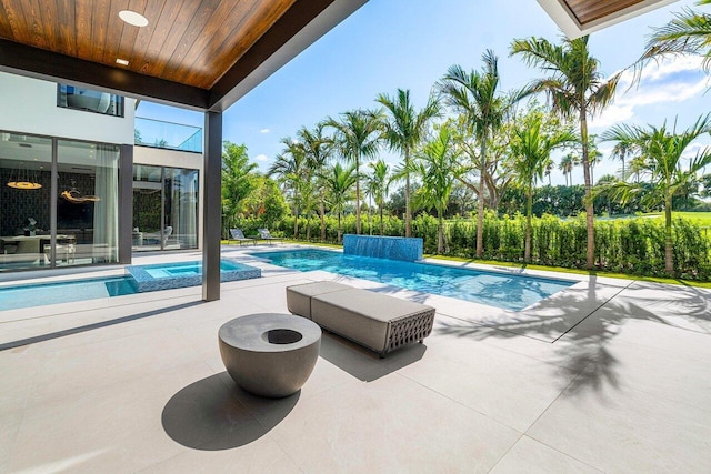 view of swimming pool featuring an in ground hot tub and a patio area