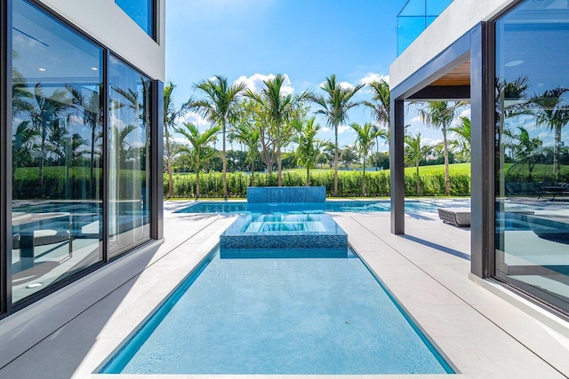 view of pool featuring an in ground hot tub and a patio area