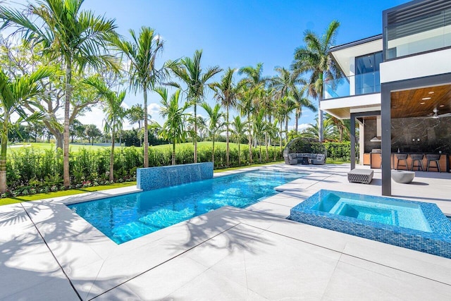 view of pool with a bar, an in ground hot tub, and a patio area