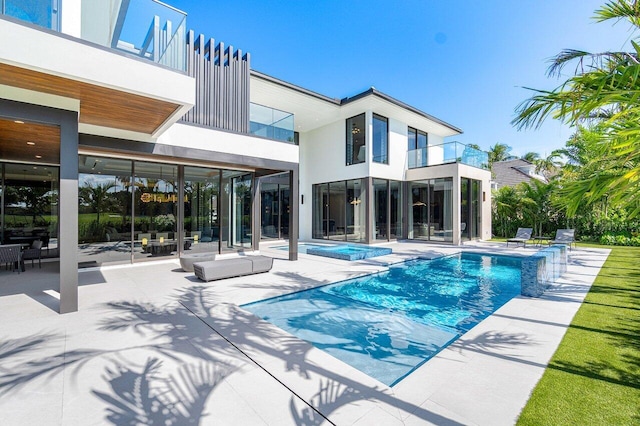 view of swimming pool with a patio area and an in ground hot tub