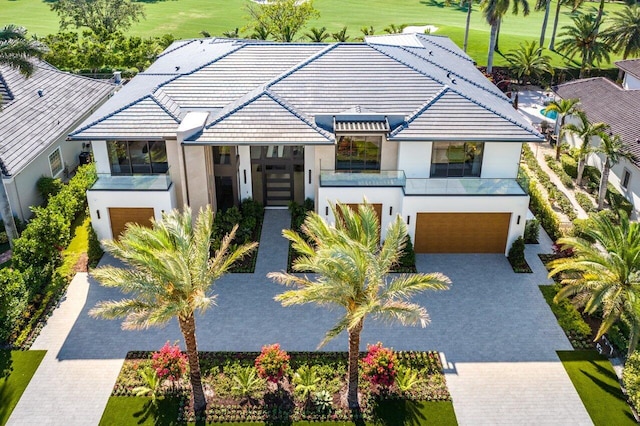 view of front of property featuring a balcony and a garage