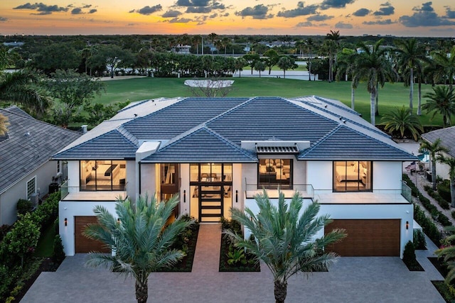 exterior space featuring a garage and a lawn