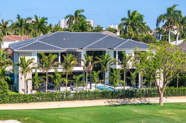 view of community with a patio, a swimming pool, and a yard