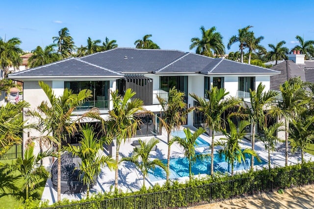 back of house with a fenced in pool