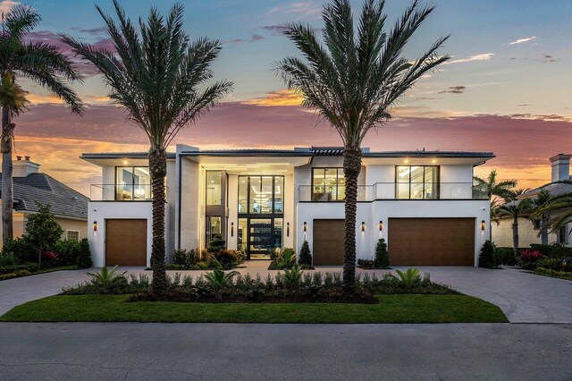 modern home featuring a balcony and a garage