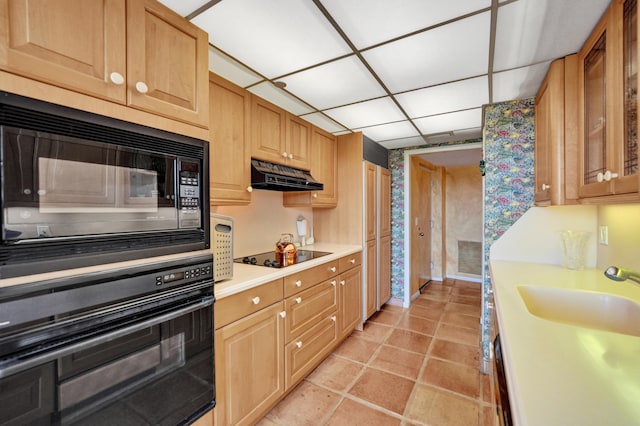 kitchen with sink, light tile flooring, and black appliances