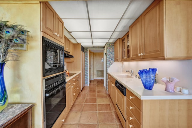 kitchen with sink, light tile floors, and black appliances